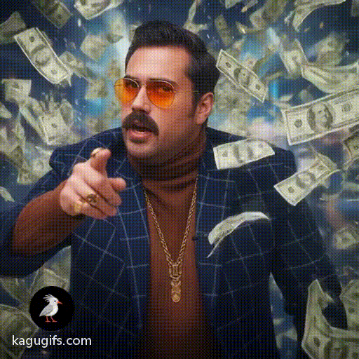 A confident man with a thick mustache wearing orange-tinted aviator sunglasses, a navy blue checkered blazer over a brown turtleneck, and gold chain necklaces with rings, gesturing expressively while being showered in falling dollar bills swirling around him.