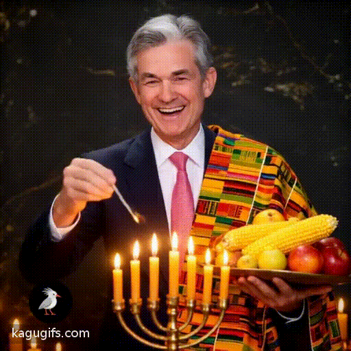 Jerome Powell, distinguished man with silver-gray hair, wearing a dark navy suit, white dress shirt, and red patterned tie, joyfully celebrating Kwanza with animated gestures, lighting the kinara candles, smiling warmly while holding traditional corn and fruit, moving rhythmically in festive celebration with colorful kente cloth draped nearby.