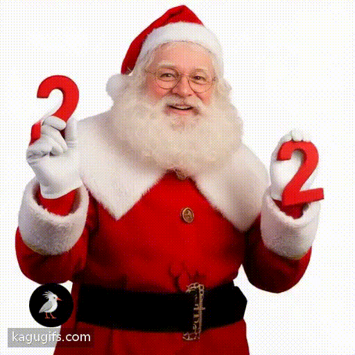 Santa with a full white beard and glasses wearing a red suit with white fur trim, cheerfully holding up the number 2 with both hands in a festive pose.