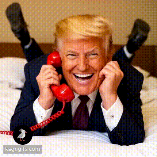 Donald Trump with distinctive golden hair and dark navy suit laying down face-first on a bed facing towards the camera with his legs kicked up in the air behind him, animatedly talking happily on a bright red telephone, smiling expression, relaxed playful pose.